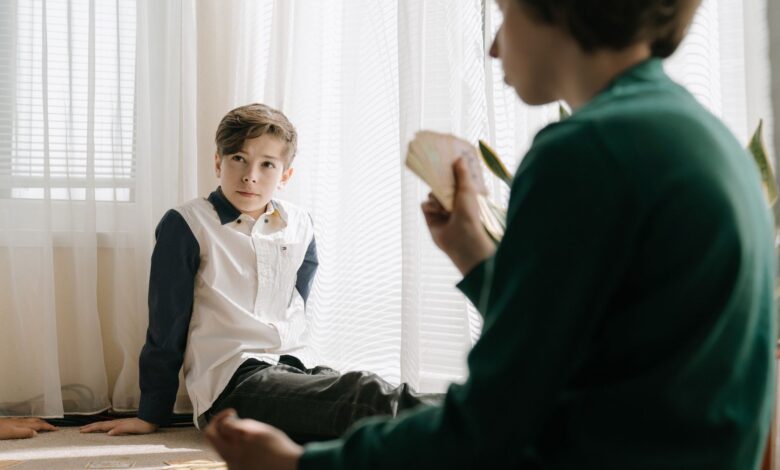 Two kids engaging in a card game indoors, enjoying leisure time and strategic gameplay.