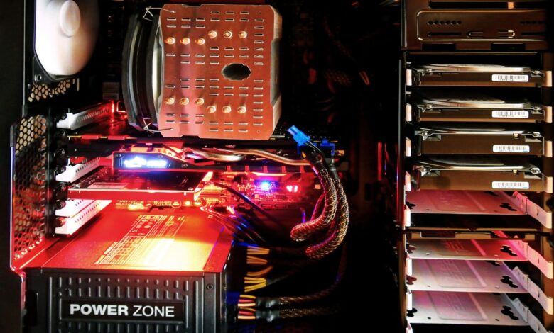 Close-up of a custom gaming PC with RGB lighting, showcasing power supply and components.