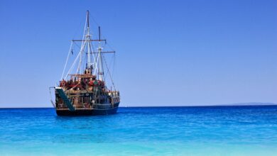 A classic pirate ship anchored near a sandy beach on Zakynthos, Greece.