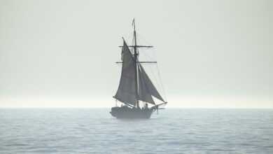 A tranquil silhouette of a sailing ship on a calm sea horizon, evoking peace and adventure.