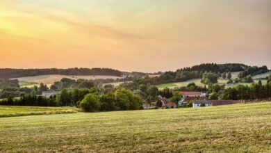 Peaceful rural landscape in Zbraslavice, Czechia at sunset with rolling hills and farmland.