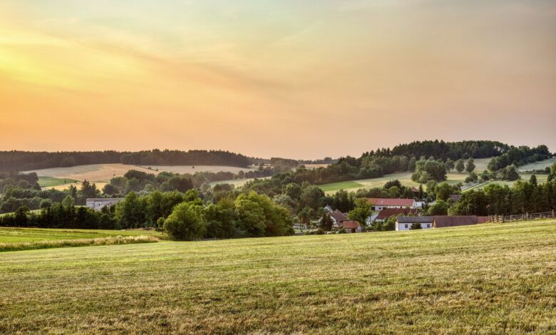 Peaceful rural landscape in Zbraslavice, Czechia at sunset with rolling hills and farmland.