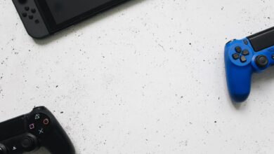 A flat lay of gaming consoles and controllers on a white surface, ideal for tech enthusiasts.