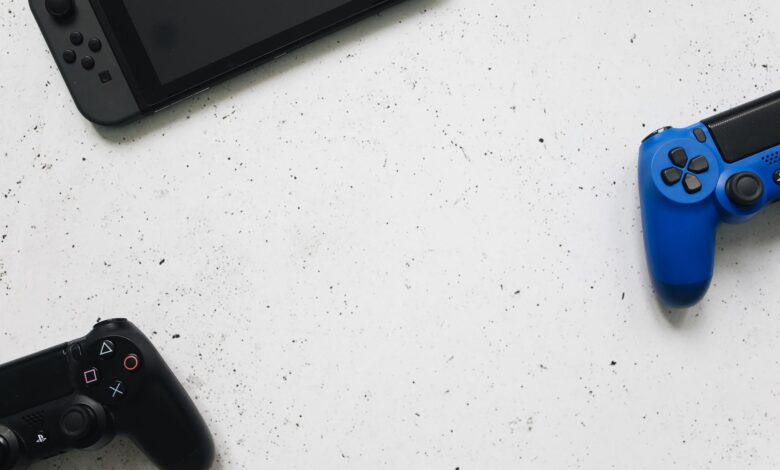 A flat lay of gaming consoles and controllers on a white surface, ideal for tech enthusiasts.