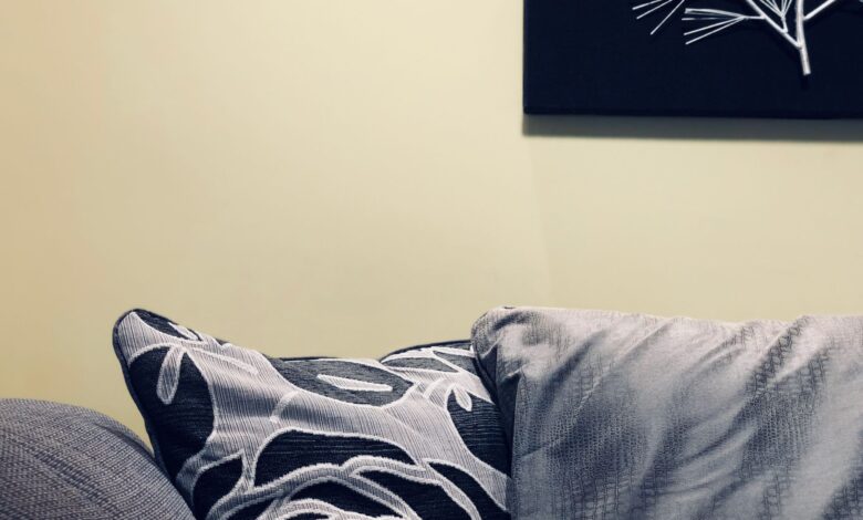 Stylish modern interior features a cozy sofa with decorative throw pillows and wall art.