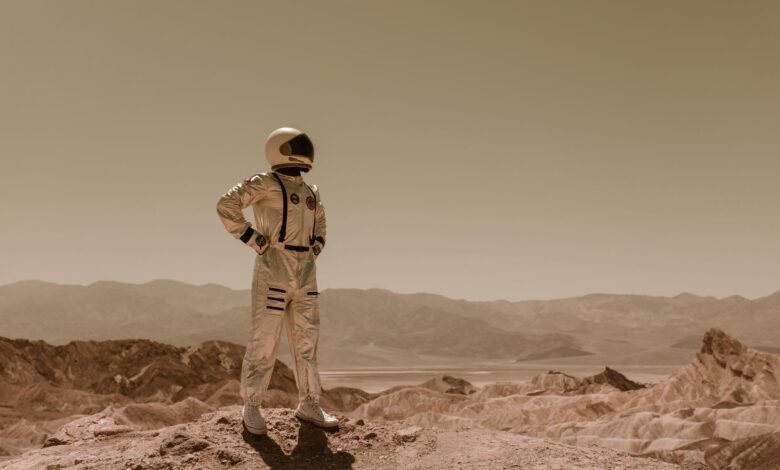 Astronaut standing in a desolate landscape, evoking sci-fi exploration on another planet.