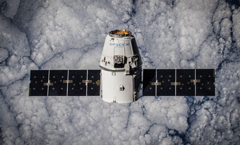 SpaceX Dragon spacecraft in orbit, highlighting advanced space technology with cloud backdrop.