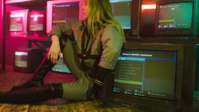 Woman in cyberpunk attire sits surrounded by vintage TVs in a neon-lit room, evoking retro-futuristic vibes.