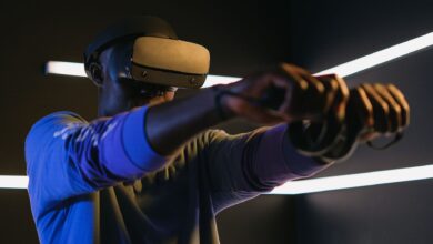 Man using VR headset and controllers in a futuristic room, engaged in gaming.