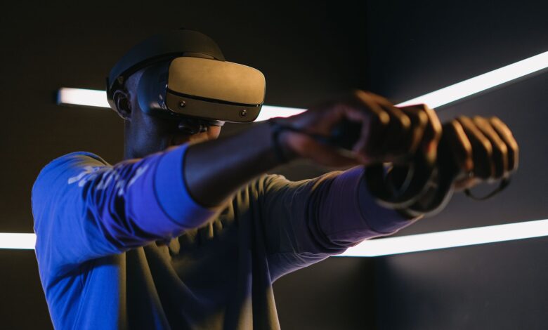 Man using VR headset and controllers in a futuristic room, engaged in gaming.