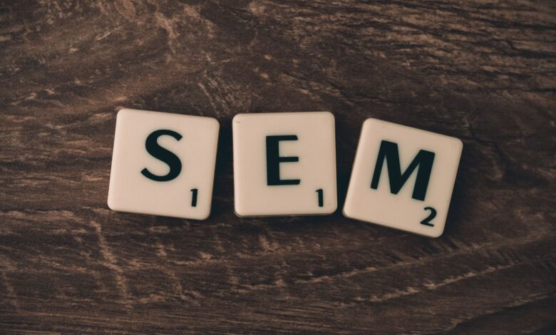 Wooden background with letter tiles spelling SEM, representing search engine marketing.