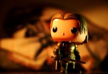 A cute toy figure in armor with dramatic light and warm tones, perfect for creative projects.