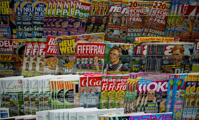 A vibrant display of magazines in a newsstand, showcasing various colorful covers and headlines.