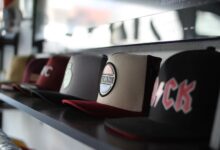 Collection of trendy baseball caps arranged on a store shelf, showcasing different designs.