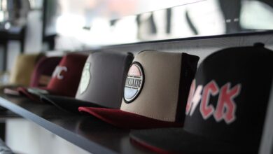 Collection of trendy baseball caps arranged on a store shelf, showcasing different designs.
