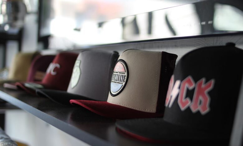 Collection of trendy baseball caps arranged on a store shelf, showcasing different designs.
