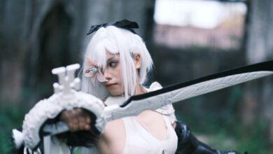 Captivating shot of a cosplayer in action with a sword amidst ancient Vietnamese ruins.