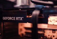 Detailed view of a GeForce RTX graphics card installed in a computer setup, highlighting modern technology.