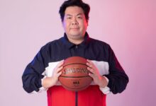 Man in sportswear with basketball against a gradient background.