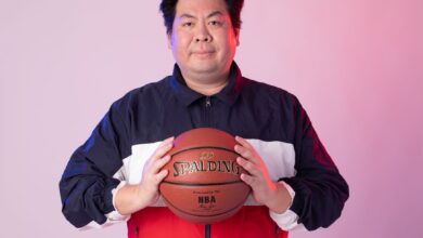 Man in sportswear with basketball against a gradient background.