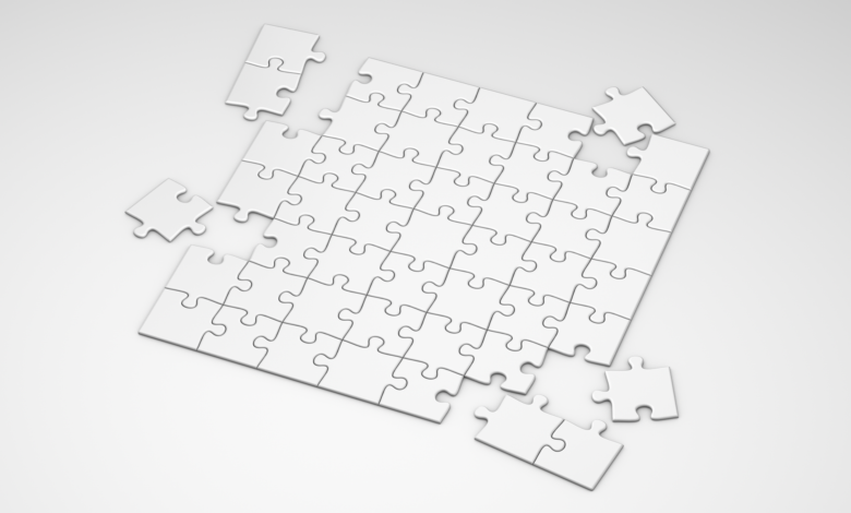A top view of incomplete white puzzle pieces on a clean, minimalist background.