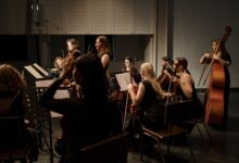 A group of professional musicians performing a classical symphony on stage.