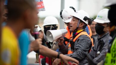 Construction workers in a heated protest with security present. Safety and communication emphasized.