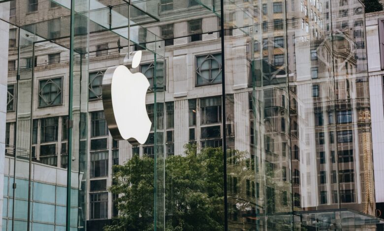 Transparent walls of modern company building with label icon against old building in downtown