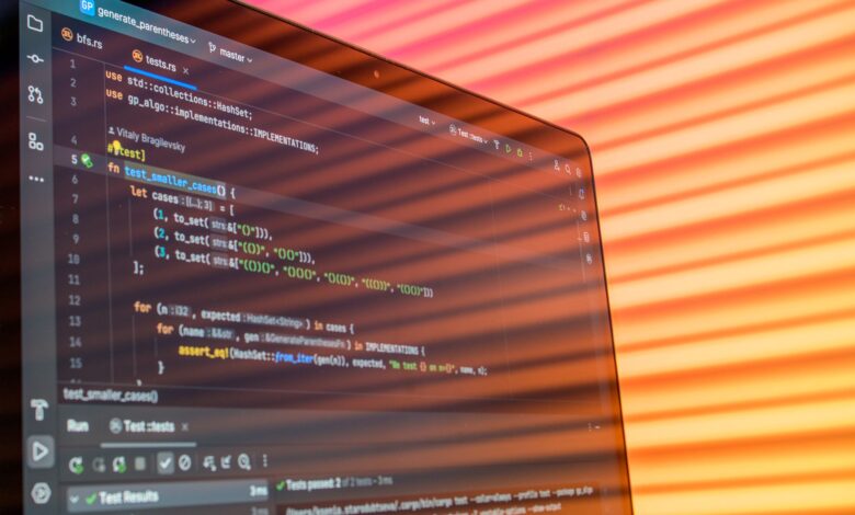 Colorful abstract reflection on screen showing programming code in development environment.