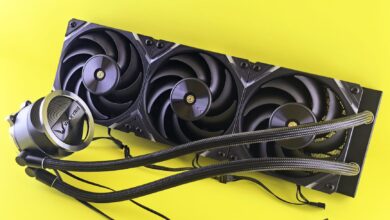 High-performance CPU cooler with a triple fan radiator on yellow background, ideal for PC upgrades.