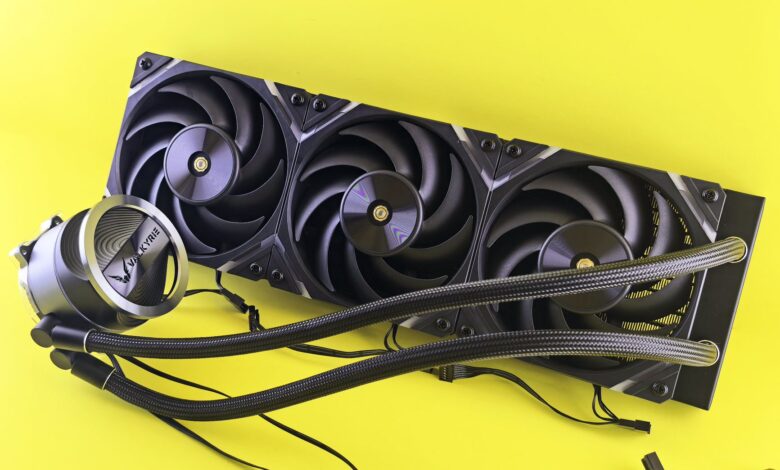 High-performance CPU cooler with a triple fan radiator on yellow background, ideal for PC upgrades.