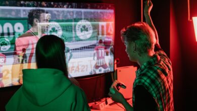 Two friends enjoying an exhilarating video game session indoors, captured with vibrant lighting.