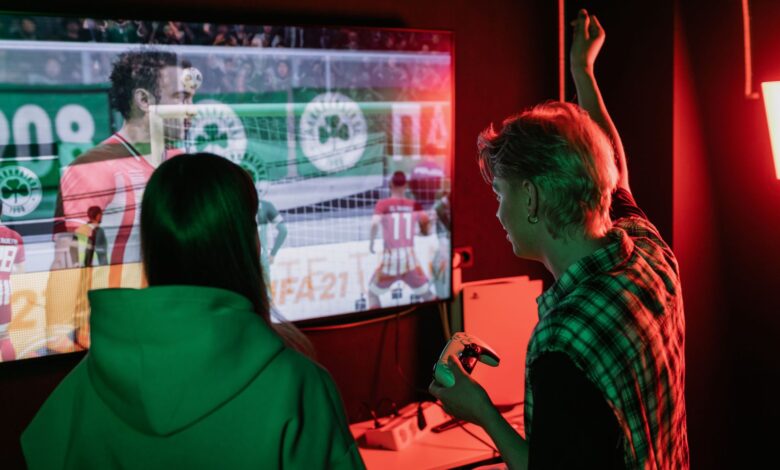 Two friends enjoying an exhilarating video game session indoors, captured with vibrant lighting.