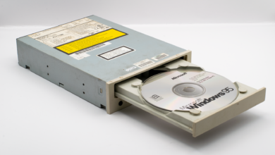 Vintage CD-ROM drive with Microsoft Windows 95 disc, iconic retro tech.