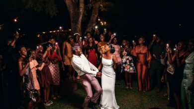 A vibrant wedding party celebrating under lights in Nigeria.