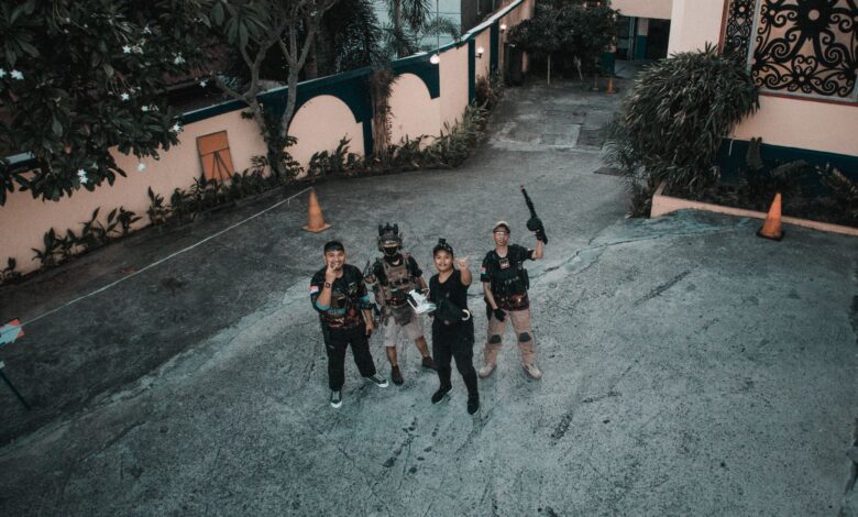 From above group of unrecognizable ethnic people in various costumes standing on street during filming movie