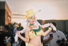 Vibrant cosplay character featuring a woman in a yellow costume at an outdoor event.