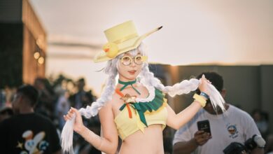 Vibrant cosplay character featuring a woman in a yellow costume at an outdoor event.