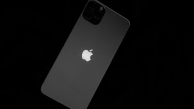 Close-up of a sleek smartphone featuring the iconic Apple logo against a black background.