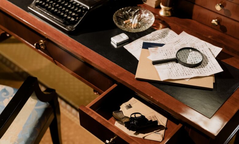 A moody vintage detective's desk with typewriter, magnifying glass, and secret documents.
