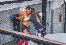 Two male fighters engaged in an MMA match demonstrating strength and agility.