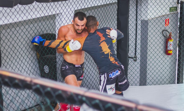 Two male fighters engaged in an MMA match demonstrating strength and agility.