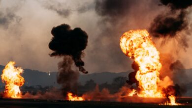 Intense fireball explosions with thick smoke in an outdoor setting. Captured during the day.