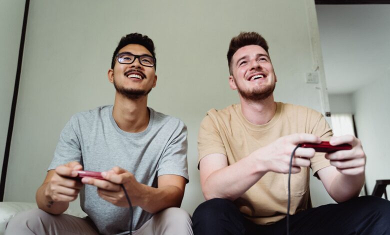 Two men happily playing video games in a modern living room.