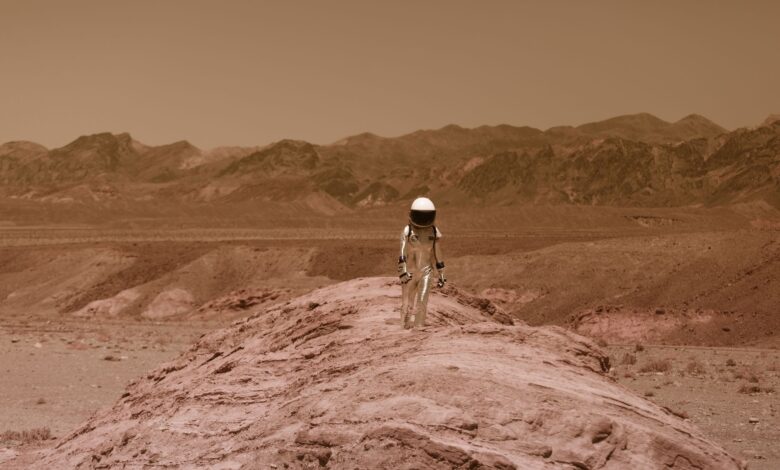 Astronaut walking on a barren, Mars-like desert landscape, depicting adventure and exploration.