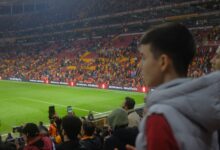 Crowd at a thrilling soccer match in Istanbul stadium with vibrant atmosphere.