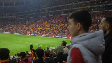 Crowd at a thrilling soccer match in Istanbul stadium with vibrant atmosphere.