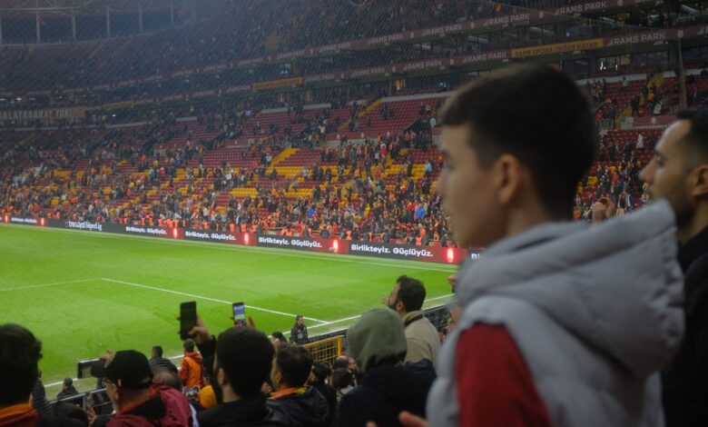 Crowd at a thrilling soccer match in Istanbul stadium with vibrant atmosphere.