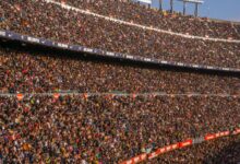 A vibrant crowd fills Camp Nou stadium, Barcelona during a football match.