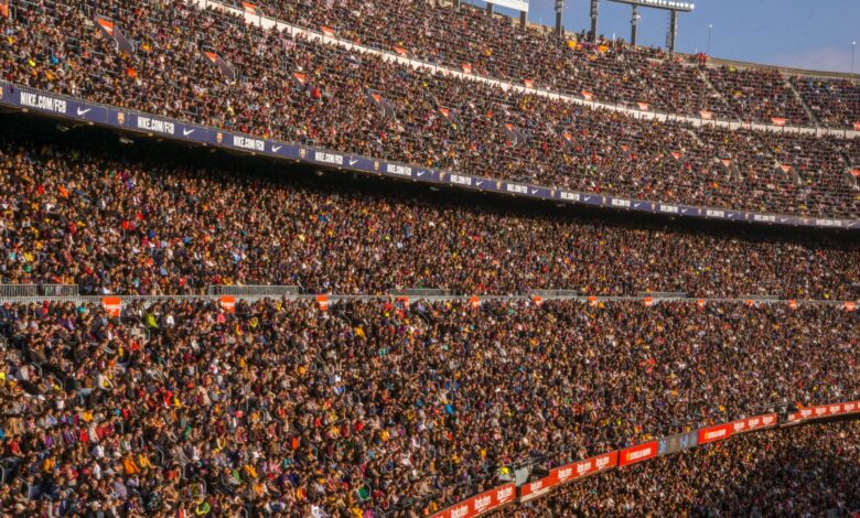 A vibrant crowd fills Camp Nou stadium, Barcelona during a football match.